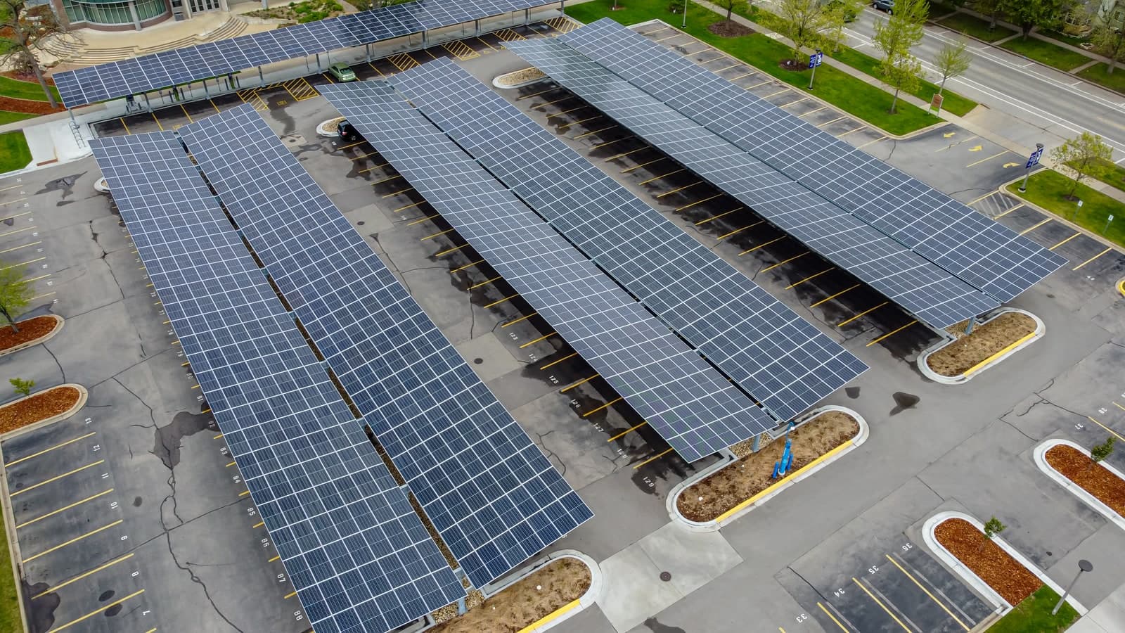 Aerial view of solar carport canopies running the length of a car park